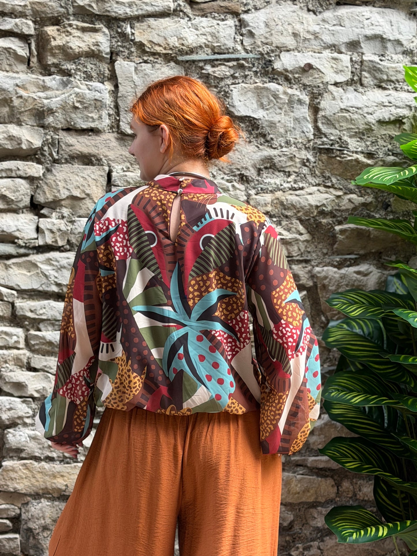High neck pattern blouse with bubble hem and elastic sleeve cuffs in one size fits 8-18 in brown